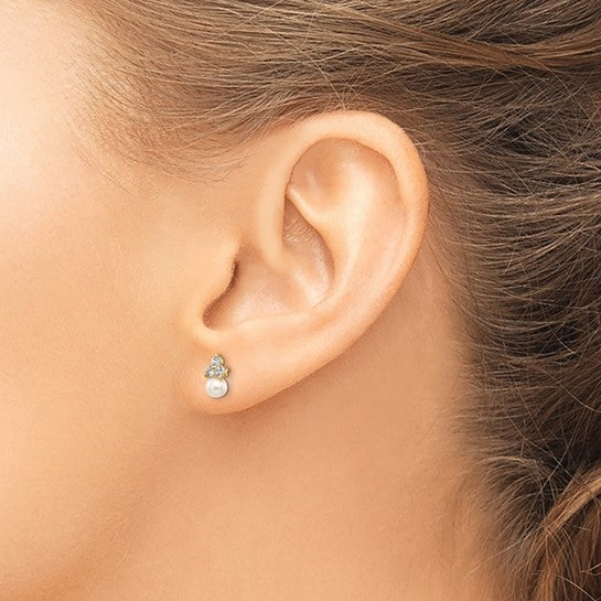 Diamond Essence Round Brilliant stone 0.10 ct each, set in group of three in floral arrangement and round freshwater cultured pearl makes a perfect post earrings for little ears. 0.60 cts.t.w. set in 14K Solid Yellow Gold.