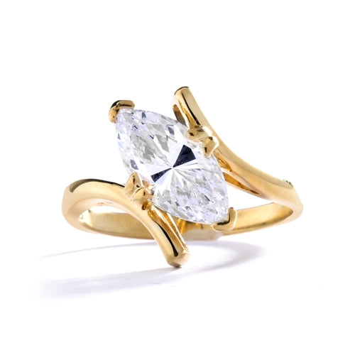 Solitaire Ring with artistically set Diamond Essence Marquise in prong setting. 1.5 Cts. T.W. set in 14K Solid Yellow Gold.