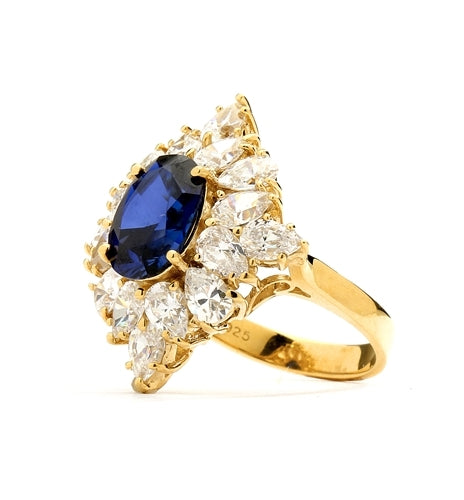 Designer ring with 3.5 Ct. oval Sapphire Essence set in four prongs, and surrounded by pear cut diamond essence stones in floral pattern. 8.5 Cts. T.W. et in 14K Solid Yellow Gold.