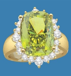 Ring with a oval cut 8.0 cts. Diamond Essence Peridot at the center, surrounded by round Diamond Essence stones, 9.0 cts.T.W. set in 14K Solid Yellow Gold.