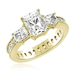 Diamond Essence Ring with Radient Emerald Center Followed by Princess cut Stones And Round Brilliant Melee on the band, 4.50 Cts.T.W. set in 14K Yellow Gold.