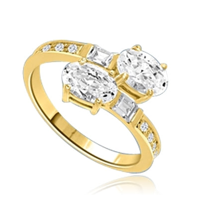 Two Oval Essence, 1.0 ct. each, set in four prongs and accompanied by baguettes and melee on band. 2.5 Cts. T.w. In 14k Solid Yellow Gold.