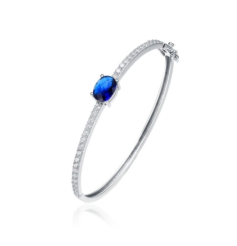 Bangle Bracelet - 2.0 Cts.Oval cut Sapphire Essence set in center with sparkling Diamond Essence Melee going around the Bangle, 4.0 Cts.T.W. set in Platinum Plated Sterling Silver.