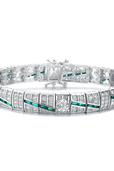 A stunner, this Platinum Plated Sterling Silver 7.25" bracelet features five round brilliant stones, 0.5 cts each, joined by melee and emerald baguettes . 14.0 cts. T.W.