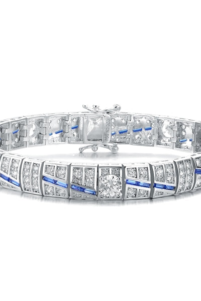 A stunner, this Platinum Plated Sterling Silver 7.25" bracelet features five round brilliant stones, 0.5 cts each, joined by melee and sapphire baguettes . 14.0 cts. T.W.