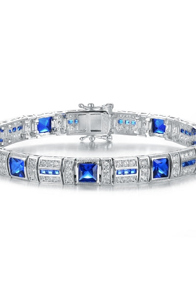 A stunner, this Platinum Plated Sterling Silver 7.25" bracelet features nine princess sapphire stones, 0.25 cts each, joined by melee. 17.0 cts. T.W.