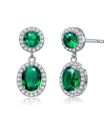 Emerald Essence 0.5 Ct. Round stones and 2.0 Cts. Oval cut stones, set in four prongs settings and surrounded by Diamond Essence Melee. Looks very attractive. 6.50 Cts.T.W. set in Platinum Plated Sterling Silver.