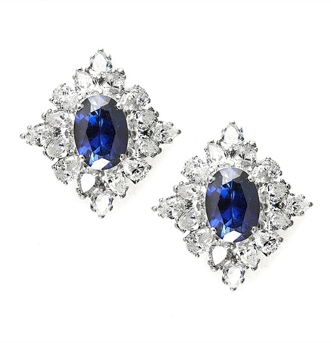 Prong Set Earrings with Simulated Oval Cut Sapphire Center and Pear Cut Diamonds by Diamond Essence set in Sterling Silver