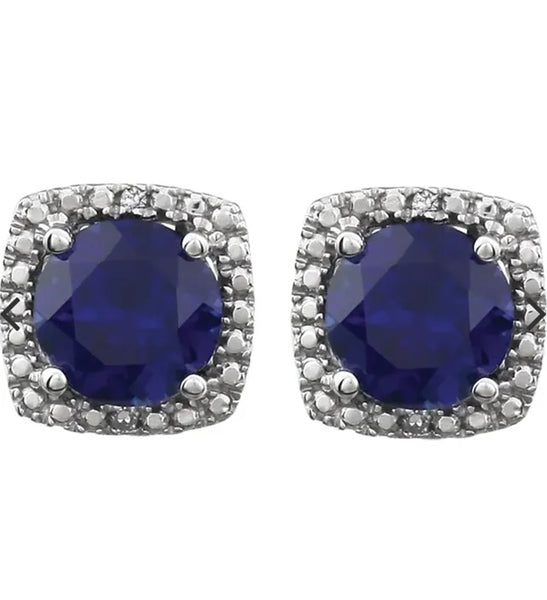 Designer Stud Earrings. One carat Sapphire Essence Round cut stone in four prongs setting and with Diamond Essence melee. 2.5 cts.t.w. in Platinum Plated Sterling Silver.