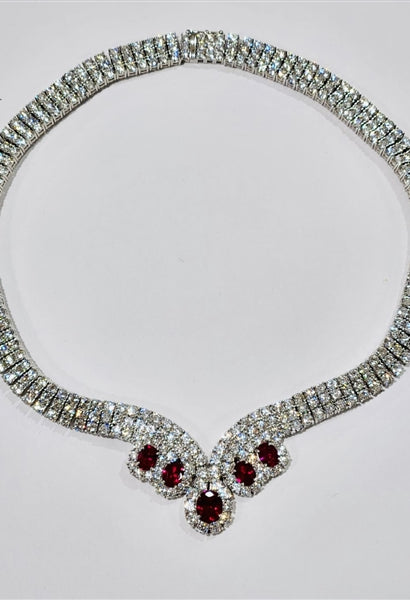 Magnificent Ruby Necklace. 3.0 Cts. Oval cut Ruby Essence in the center and 1.50 Cts. each Ruby Essence encircled by Diamond Essence stones. making 3 rows all around neckline. Special lock- on clasp to secure it. Just perfect to make any day a special day