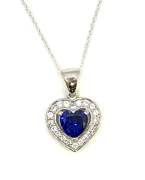 Heart shape Sapphire Essence stone in prong setting, is surrounded by round brilliant Diamond Essence stones, making another heart. 2.5 cts.t.w. in Platinum Plated Sterling Silver.