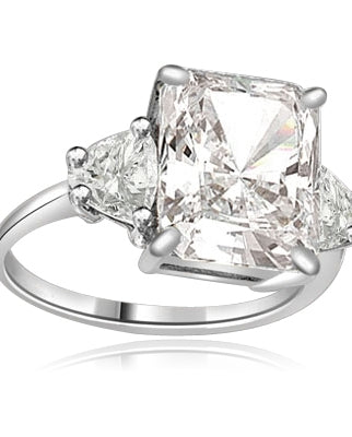 Diamond Essence emerald-cut brilliant stone of 5.0 cts. setting with trilliant baguette on each side. 6 cts.T.W. set in Platinum Plated Sterling Silver.