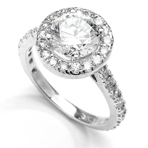 Diamond Essence Halo Setting Designer Ring With 2 Cts. Round Center and Melee around And On The Band, 4.50 Cts.T.W. In Platinum Plated Sterling Silver.