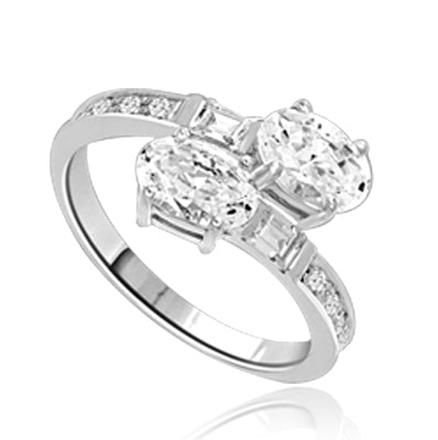 Two Oval Essence, 1.0 ct. each, set in four prongs and accompanied by baguettes and melee on band. 2.5 Cts. T.w. In Platinum Plated Sterling Silver.