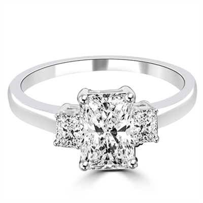 Brilliant Radiant Emerald Cut 3 Stone Ring With perfect balance Of 2.0 Cts. Brilliant Center and 0.5 Ct Sides. 3.0 Cts. T.W. set in Platinum Plated Sterling Silver.