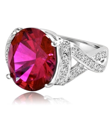Ruby Ring- 6.0 Cts Oval Cut Ruby Essence in center accompanied by Melee on the band making criss cross design. 6.50 Cts. T.W. set in Platinum Plated Sterling Silver.