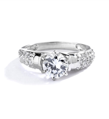 Engagement Ring- Tiffany set, 1.0 Ct Round Brilliant Diamond Essence in center with cluster of sparkling Melee on the band. 1.25 Cts T.W. set in Platinum Plated Sterling Silver.