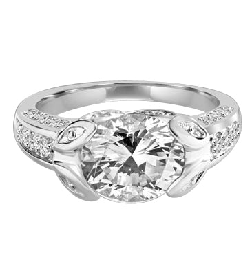 Designer Ring with 3.0 Cts. Round Brilliant Diamond Essence, artistically set in leaf shaped prongs in center, set off by Melee on either side of the band. 4.0 Cts. T.W. set in Platinum Plated Sterling Silver.