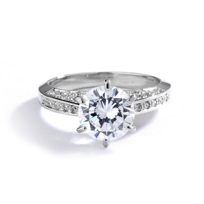Diamond Essence Designer Ring with 2.0 Cts. Round Brilliant Diamond Essence in Center and melee set on three sides of band, 3.90 Cts. T.W. set in Platinum Plated Sterling Silver.