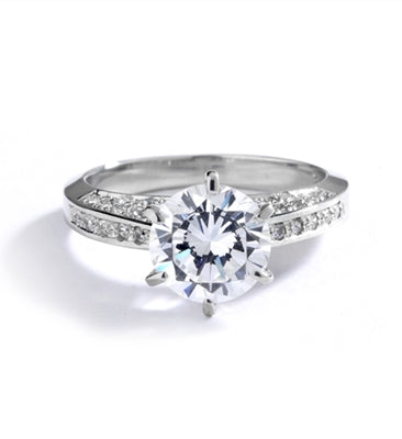 Diamond Essence Designer Ring with 2.0 Cts. Round Brilliant Diamond Essence in Center and melee set on three sides of band, 3.90 Cts. T.W. set in Platinum Plated Sterling Silver.