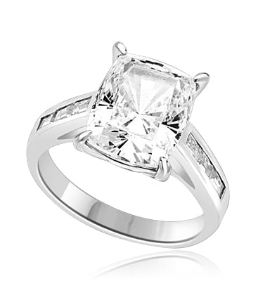 4CT Radiant Emerald Essence Tapered brilliantly to sparkle even more, and the band is further enhanced by 3 Baguettes Stones artistically channel set. 5 Cts. T.W. In Platinum Plated Sterling Silver.