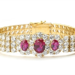 7" long Diamond Essence Bracelet with 2.0 Ct. Ruby in center and 1.0 Ct. Ruby on each side encircled by Diamond Essence stones making 3 rows all around wrist. Appx. 40.0 Cts. T.W. set in 14K Gold Vermeil.