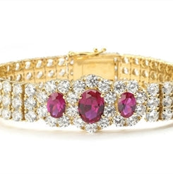7" long Diamond Essence Bracelet with 2.0 Ct. Ruby in center and 1.0 Ct. Ruby on each side encircled by Diamond Essence stones making 3 rows all around wrist. Appx. 40.0 Cts. T.W. set in 14K Gold Vermeil.