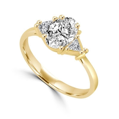 Stunning Ring, 2 Cts. T.W, with 1 Ct Oval Cut Emerald Center and White Trilliant Diamond Essence Stones on side, in Gold Vermeil.