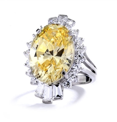 Diamond Essence Designer ring in 14K Solid White Gold with 10 cts. Oval Canary center. Round Essence and Baguettes on either side, set in prong settings, makes it a classic cocktail ring. 13.0 cts.T.W.