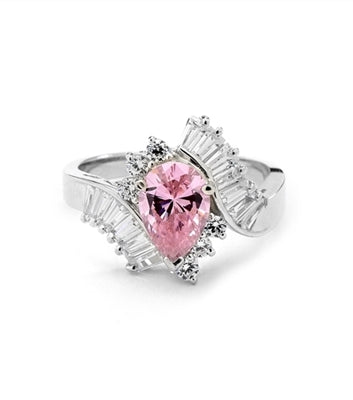 A beautiful designer ring. Diamond Essence Pink Pear cut stone of 2.5 carat supported by round brilliant melees and artistically curved shank with brilliant baguettes gives an extraordinary look and compliments. Must have one. 4.80 cts.t.w.