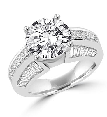 Diamond Essence Designer Ring with 3.50 Cts. Round Brilliant Center, set off by Chanel set Princess stones and Tapered Baguettes on either side.5.50 Cts.T.W. set in 14K Solid White Gold.