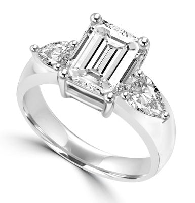 Brilliant Ring with 3 carat Radient Emerald Diamond Essence with 0.5 carat Pear cut Diamond Essence on each side. 4.0 cts.t.w. in 14K Solid White Gold.