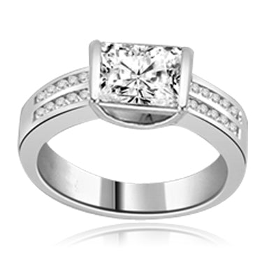 A unique East-West design, with a Channel Set 1.5 Ct. Radiant Emerald Cut Diamond Essence Centerand a bevy of Melee accents down the band for an exhilarting sensation, in 14K White Gold.