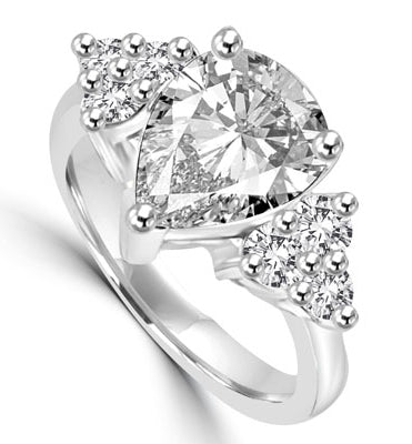 Blinding Beauty - She'll adore this outsized 2 Ct. Pear Shaped white Brilliant Diamond Essence masterpiece set with 3 dazzling round stones on either side of the band. Outstanding value for 2.30 Cts. T.W. in 14K Solid White Gold.
