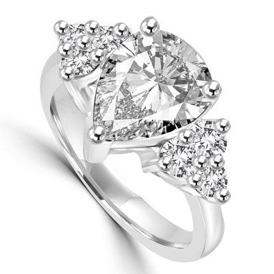 Blinding Beauty - She'll adore this outsized 2 Ct. Pear Shaped white Brilliant Diamond Essence masterpiece set with 3 dazzling round stones on either side of the band. Outstanding value for 2.30 Cts. T.W. in 14K Solid White Gold.