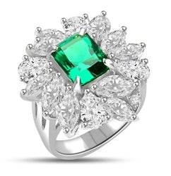 Diamond Essence classic cocktail ring. 2.5 Ct. Radient Emerald cut Emerald Essence surrounded by marquise cut and pear cut Diamond Essence in floral setting. 11.0 cts.t.w set in 14K Solid White Gold.