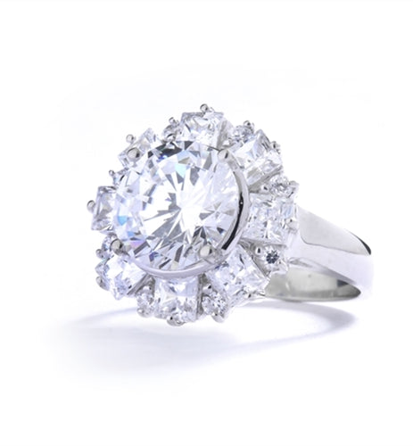 Diamond Essence Designer Ring With Round Brilliant Diamond Essence in center surrounded by alternately set Princess and melee. 7.25 Cts. T.W. set in 14K Solid White Gold.