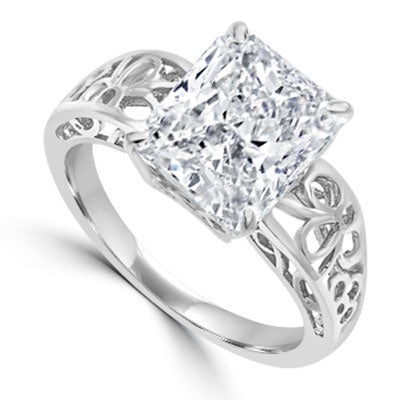 In this finely created ring, a 4 Ct. Radiant Emerald White Brilliant Stone is crafted atop an ethic set wide band. In 14k Solid Yellow Gold.