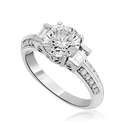 You will surly be pleased with this stunning new design. 2 Ct. Round Brilliant Diamond Essence Masterpiece is accentuated by channel baguettes and round melee on band. Ethnic carving on band makes this a uniquely adorable piece to collect. 2.75 Cts. T.W.