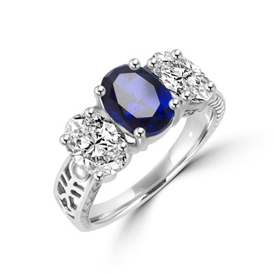 Ovalinas - Three Stone Oval Ring with 2 Ct. Oval Masterpiece on an Ethnic Band and 1.5 Ct.Oval Essence on each side, 5 ct t.w. in Platinum Plated Sterling Silver. Center Stone changeable to Many Options.