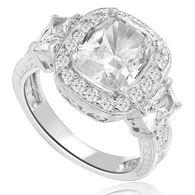 A 4 Ct Sparkling Ring with Radiant Emerald Cut is adorned by Brilliance on all sides of Round Accents and smaller Radiant Emerald on band. A stupendous 6.5 Cts. T.W. In Platinum Plated Sterling Silver.