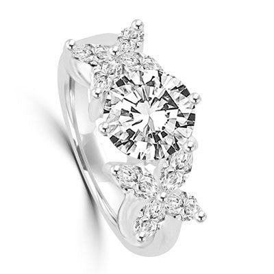 Unusual Ring with a 2.0 Ct. Round Brilliant cut Diamond Essence center stone supported by a vibrant "X" on each side with 8 Marquise Cut Masterpieces. 3.2 Cts. T.W, in 14K Solid White Gold.